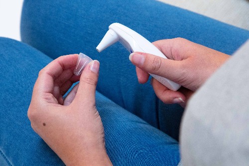 fitting an ear thermometer cover